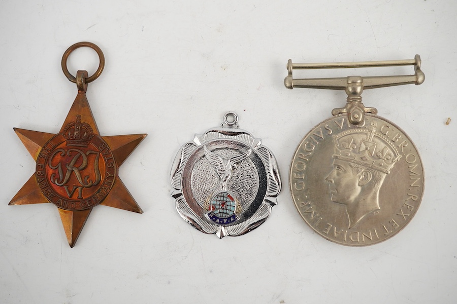 A WWII Defence medal and The France and Germany Star together with a cased Royal Navy Reserve Decoration, plus a Royal Air Force Association medallion, (4). Condition - fair to good.